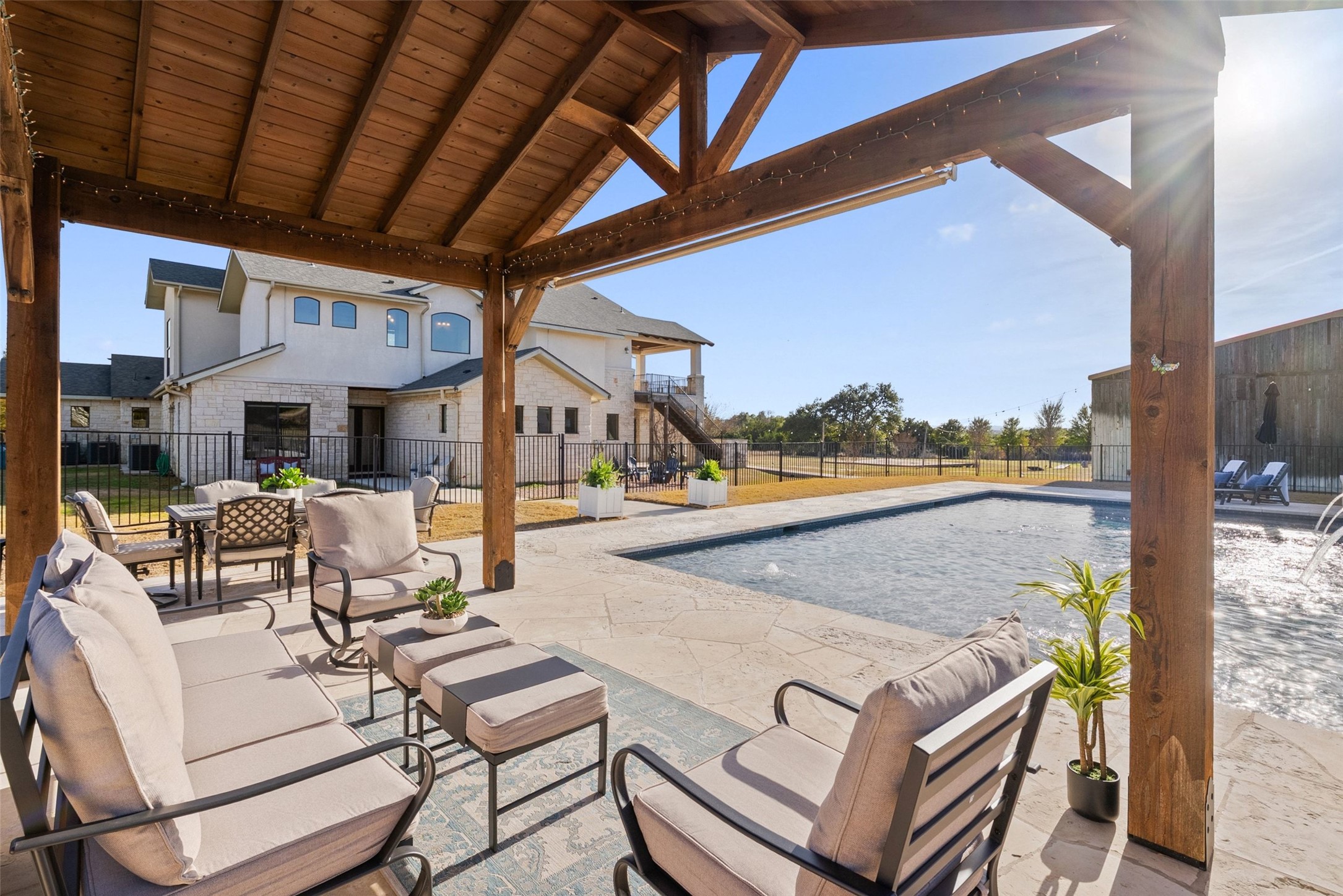 7220 Creek Road Dripping Springs, TX 78620 - Photo 38 of 40 a view of a patio with couches and pool