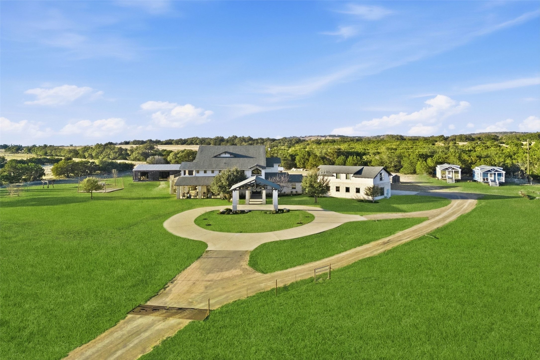 7220 Creek Road Dripping Springs, TX 78620 - Photo 39 of 40 a view of a fountain in front of a house with a big yard