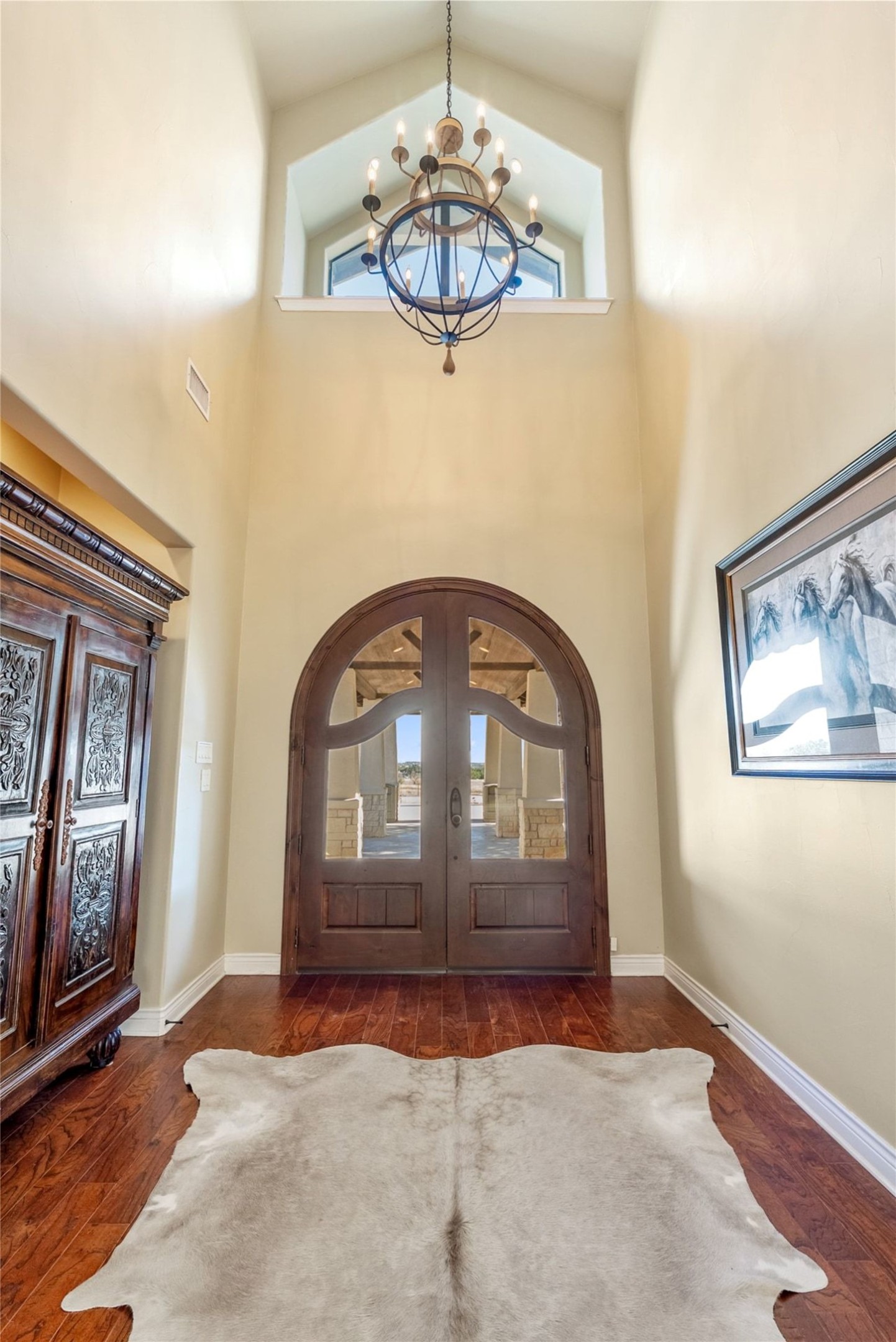 7220 Creek Road Dripping Springs, TX 78620 - Photo 4 of 40 Entryway featuring french doors, a chandelier, dark wood finished floors, and a high ceiling