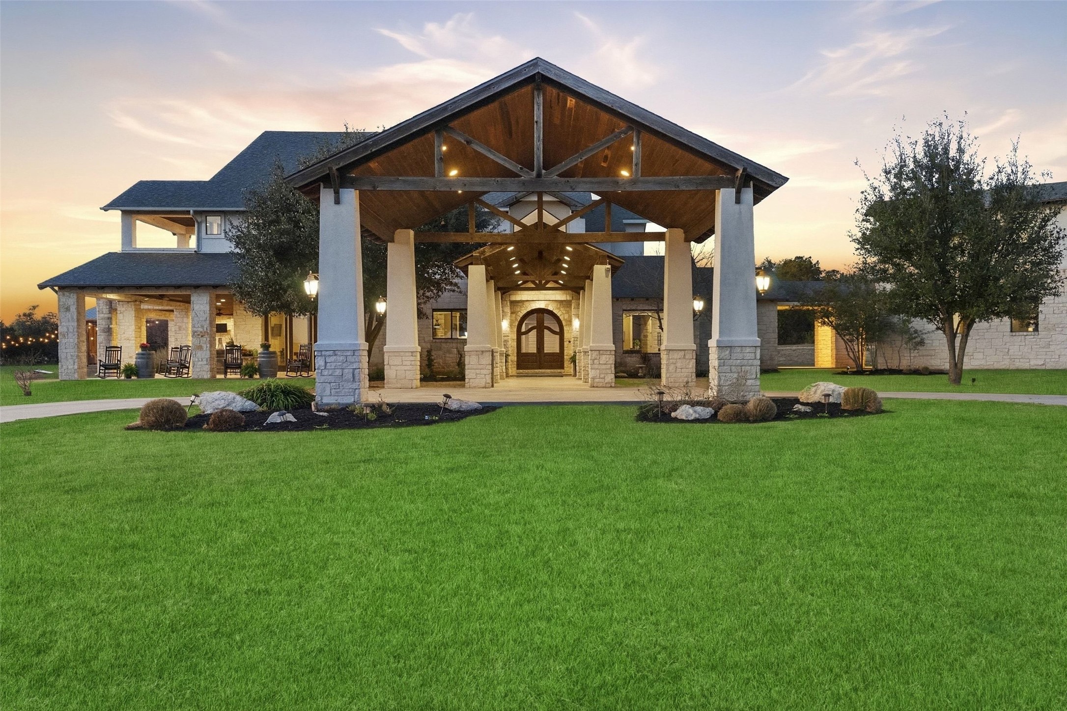 7220 Creek Road Dripping Springs, TX 78620 - Photo 4 of 40 a front view of a house with a garden