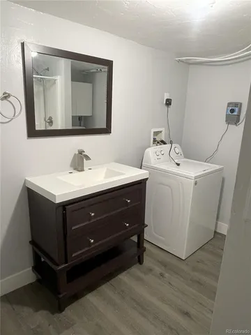 a room with a sink a mirror and cabinets
