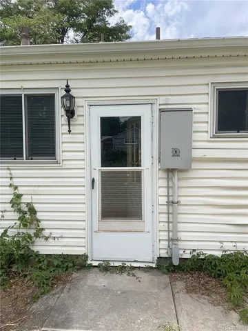 a view of a house with white door and a yard