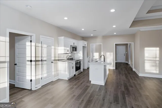 a view of kitchen with refrigerator and wooden floor