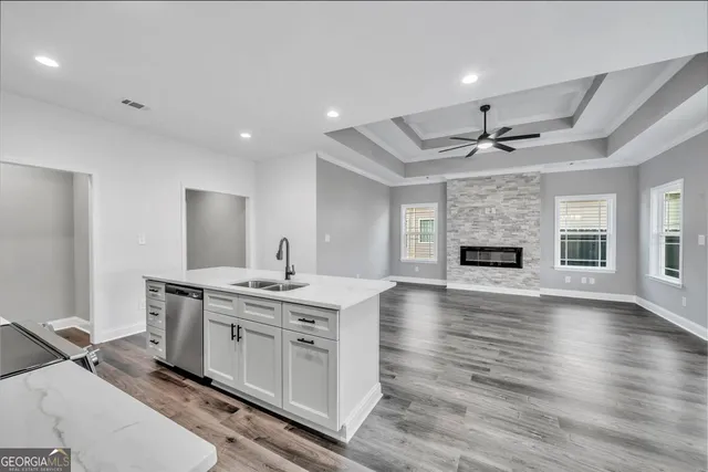 a view of kitchen with sink stove and refrigerator