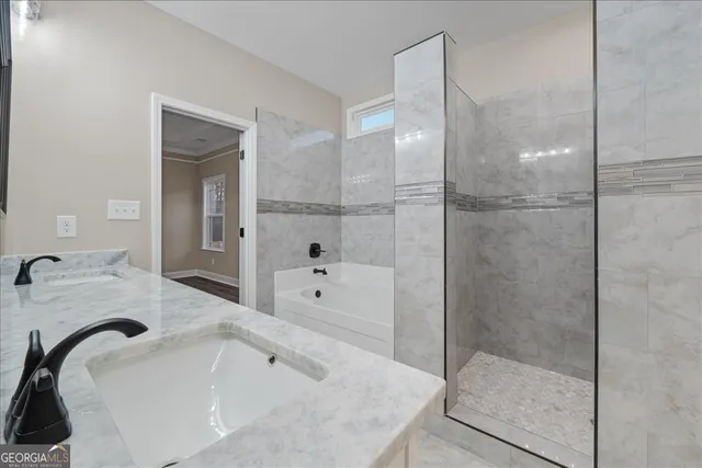 a bathroom with a tub sink and mirror