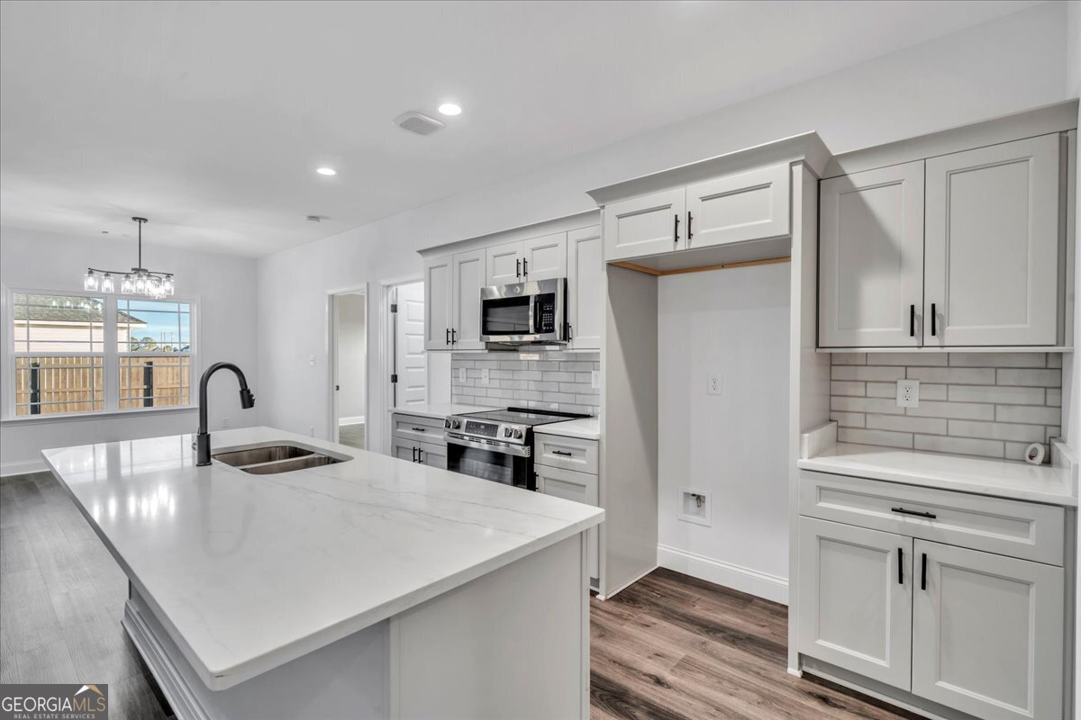 202 Eric Court Byron, GA 31008 - Photo 17 of 44 a kitchen with stainless steel appliances granite countertop a sink refrigerator and cabinets