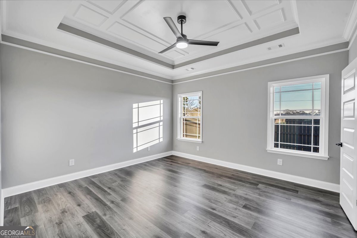 202 Eric Court Byron, GA 31008 - Photo 20 of 44 a view of an empty room with a window and wooden floor