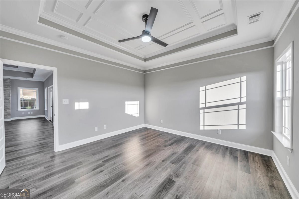 202 Eric Court Byron, GA 31008 - Photo 23 of 44 a view of an empty room with wooden floor and a window