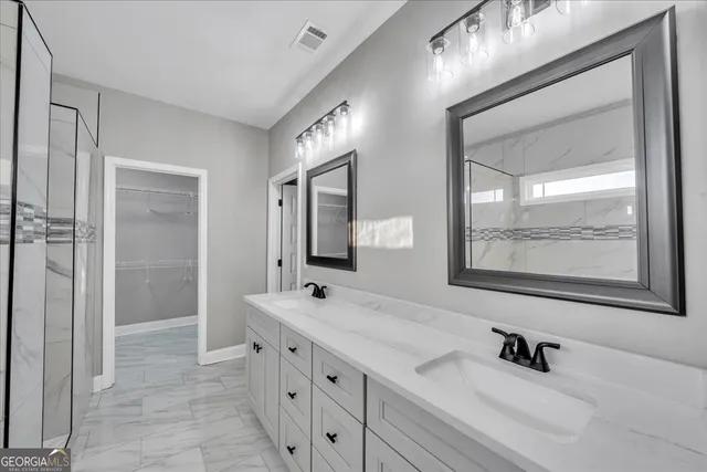 a bathroom with a double vanity sink mirror and shower