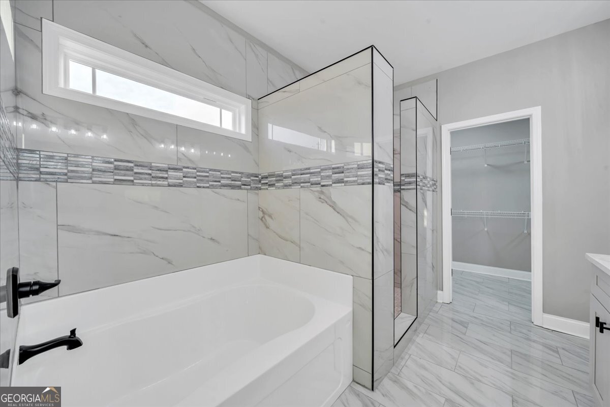 202 Eric Court Byron, GA 31008 - Photo 25 of 44 a bathroom with a bathtub and a shower