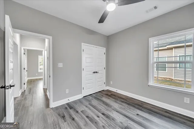 wooden floor in an empty room with a window
