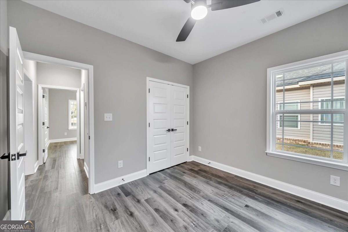 202 Eric Court Byron, GA 31008 - Photo 38 of 44 wooden floor in an empty room with a window