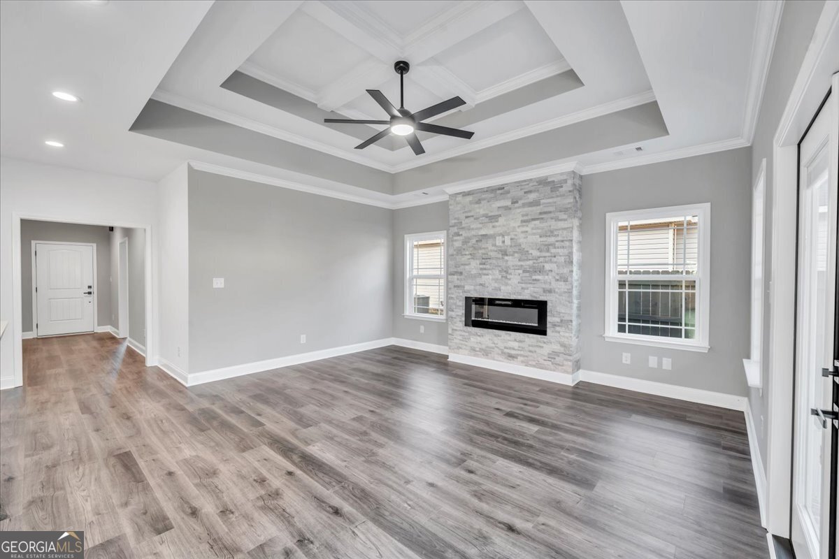 202 Eric Court Byron, GA 31008 - Photo 8 of 44 a view of an empty room with wooden floor fireplace and a window