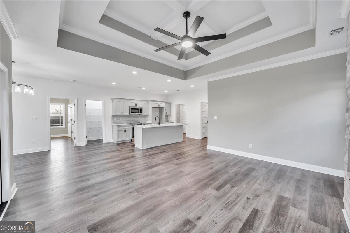 202 Eric Court Byron, GA 31008 - Photo 9 of 44 a view of a livingroom with a ceiling fan wooden floor and a ceiling fan