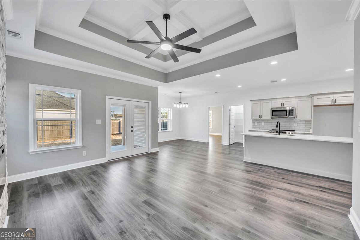 202 Eric Court Byron, GA 31008 - Photo 10 of 44 a view of an empty room with wooden floor and a ceiling fan