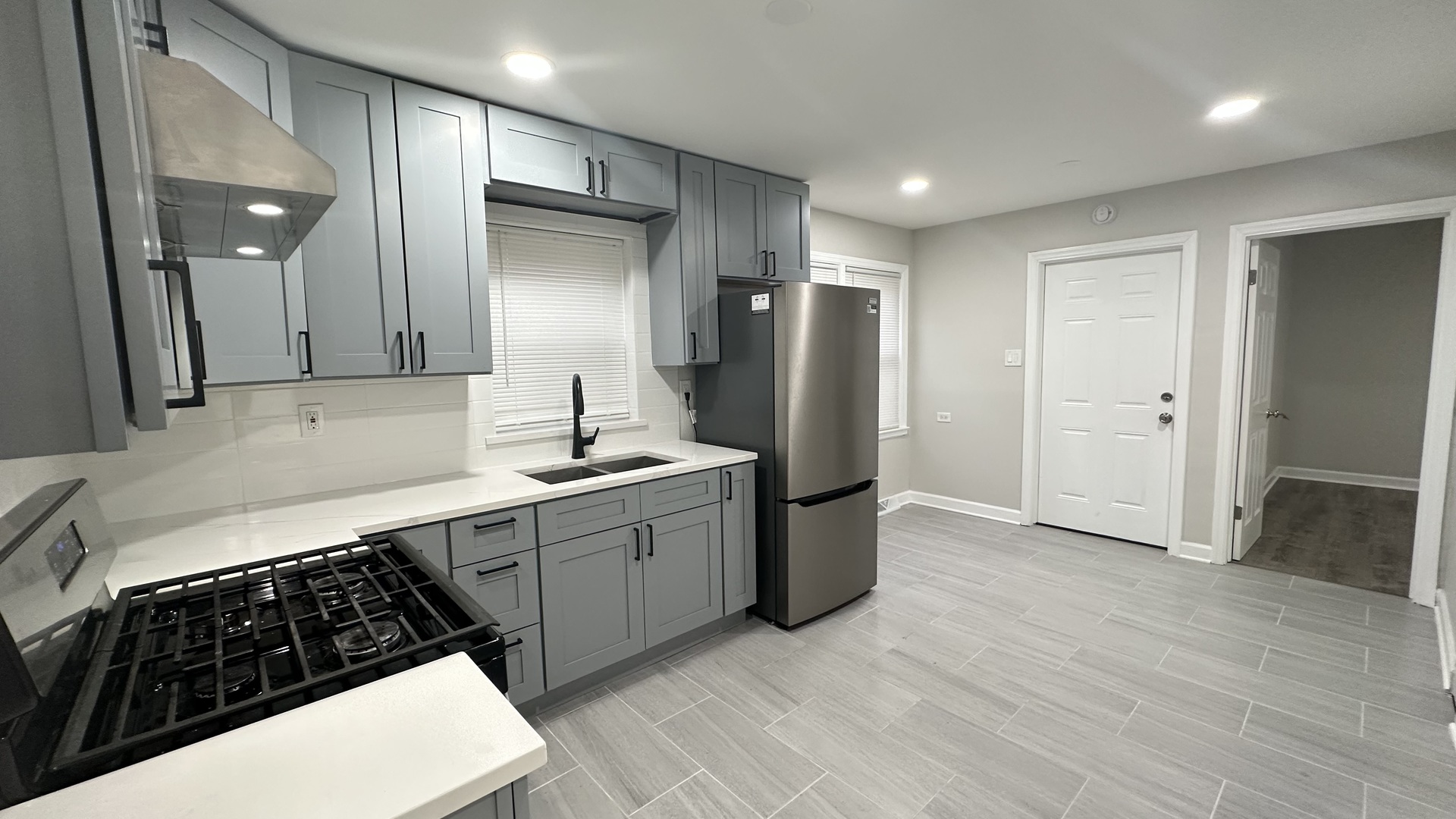 5715 North Spaulding Avenue, Unit 1 Chicago, IL 60659 - Photo 11 of 15 a kitchen with stainless steel appliances a sink stove and refrigerator