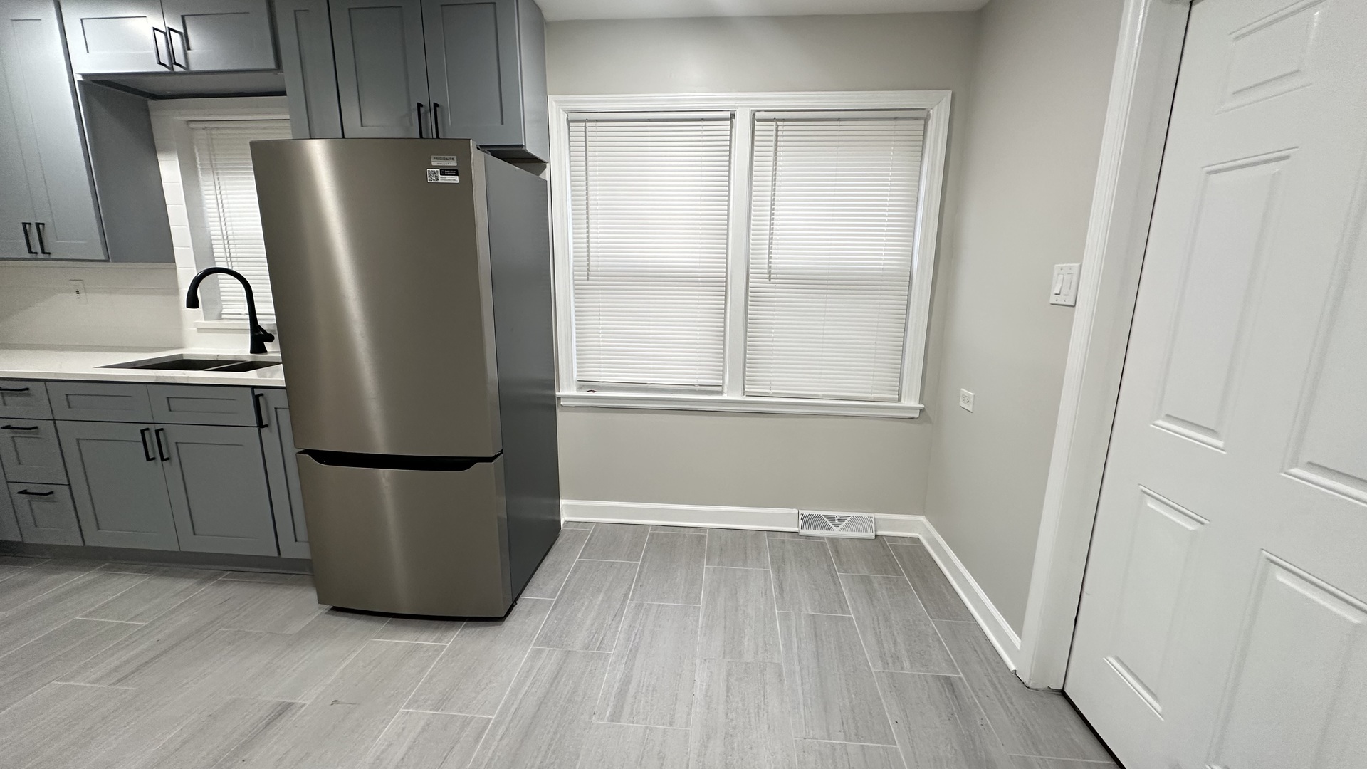 5715 North Spaulding Avenue, Unit 1 Chicago, IL 60659 - Photo 12 of 15 a view of a refrigerator in kitchen and wooden floor