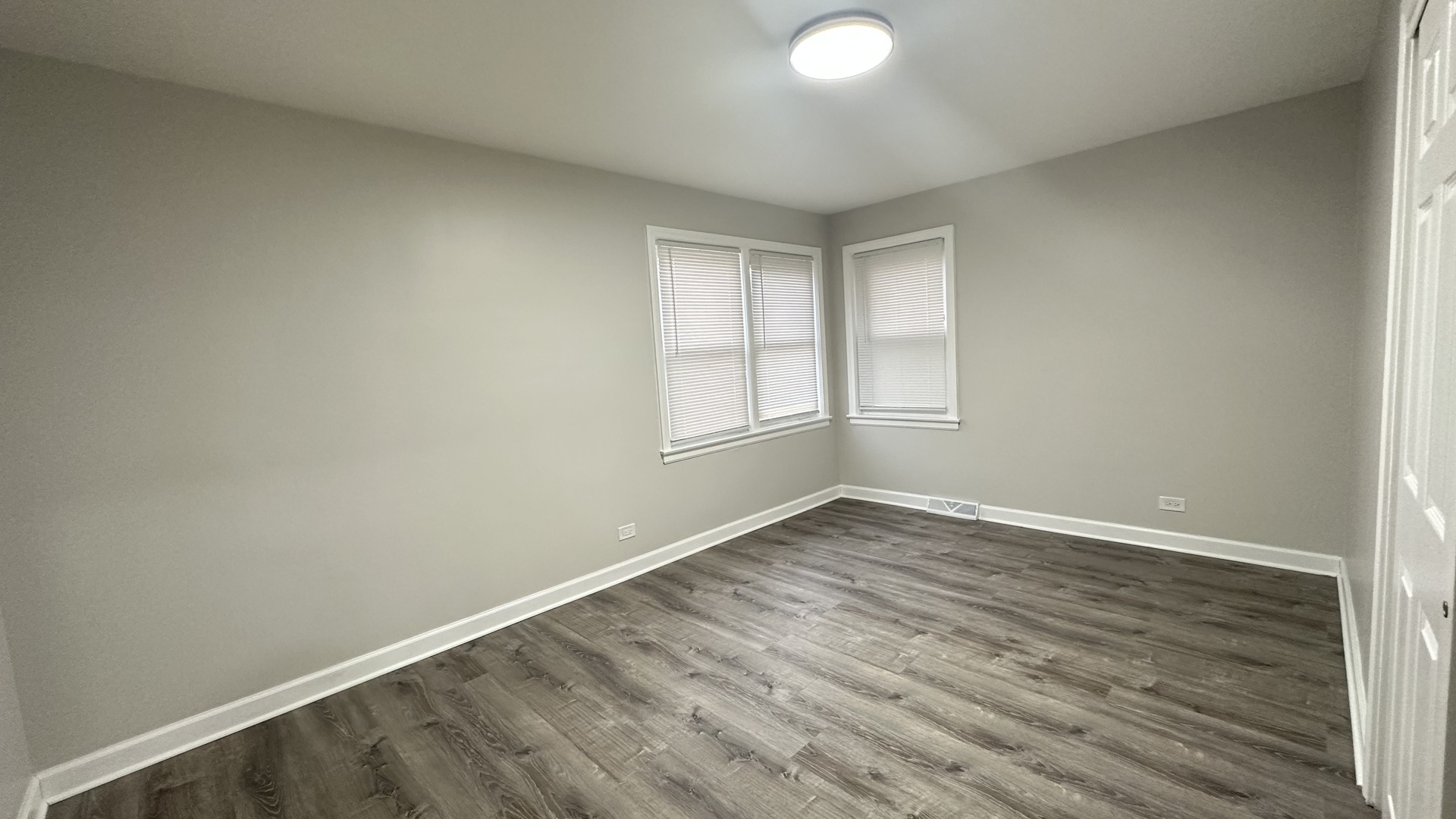 5715 North Spaulding Avenue, Unit 1 Chicago, IL 60659 - Photo 13 of 15 an empty room with wooden floor and windows