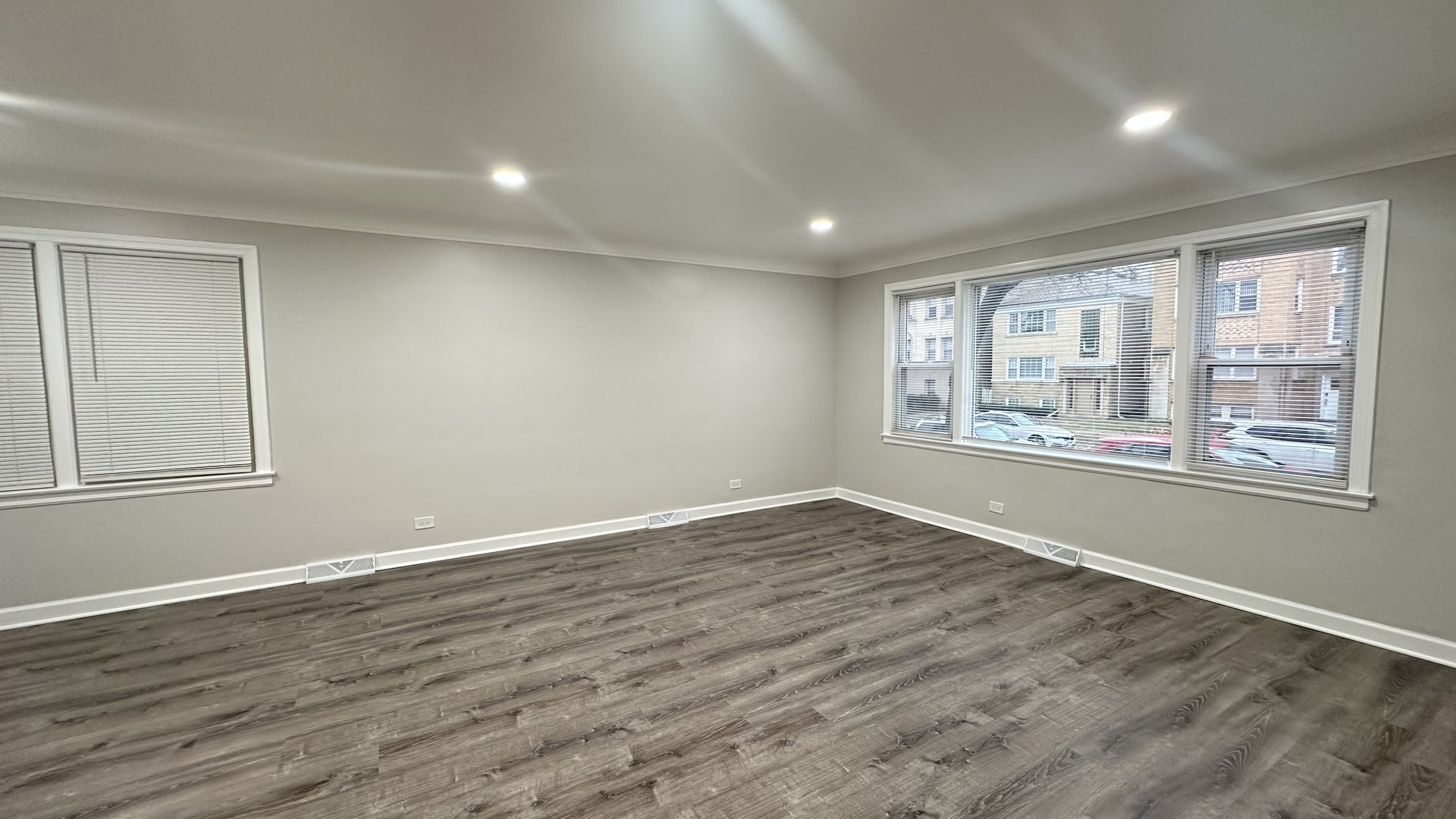 5715 North Spaulding Avenue, Unit 1 Chicago, IL 60659 - Photo 2 of 15 a view of an empty room with wooden floor and a window