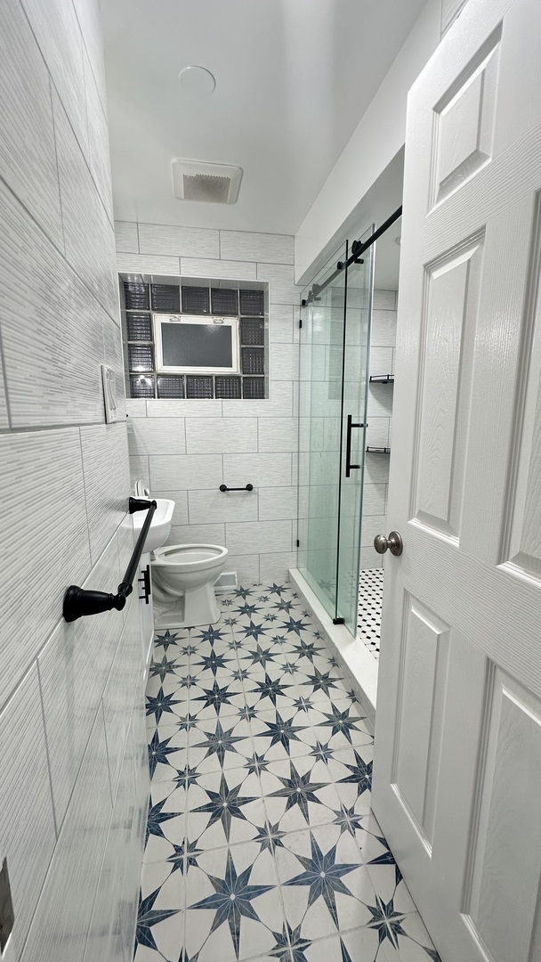 5715 North Spaulding Avenue, Unit 1 Chicago, IL 60659 - Photo 7 of 15 a bathroom with a sink a toilet and shower