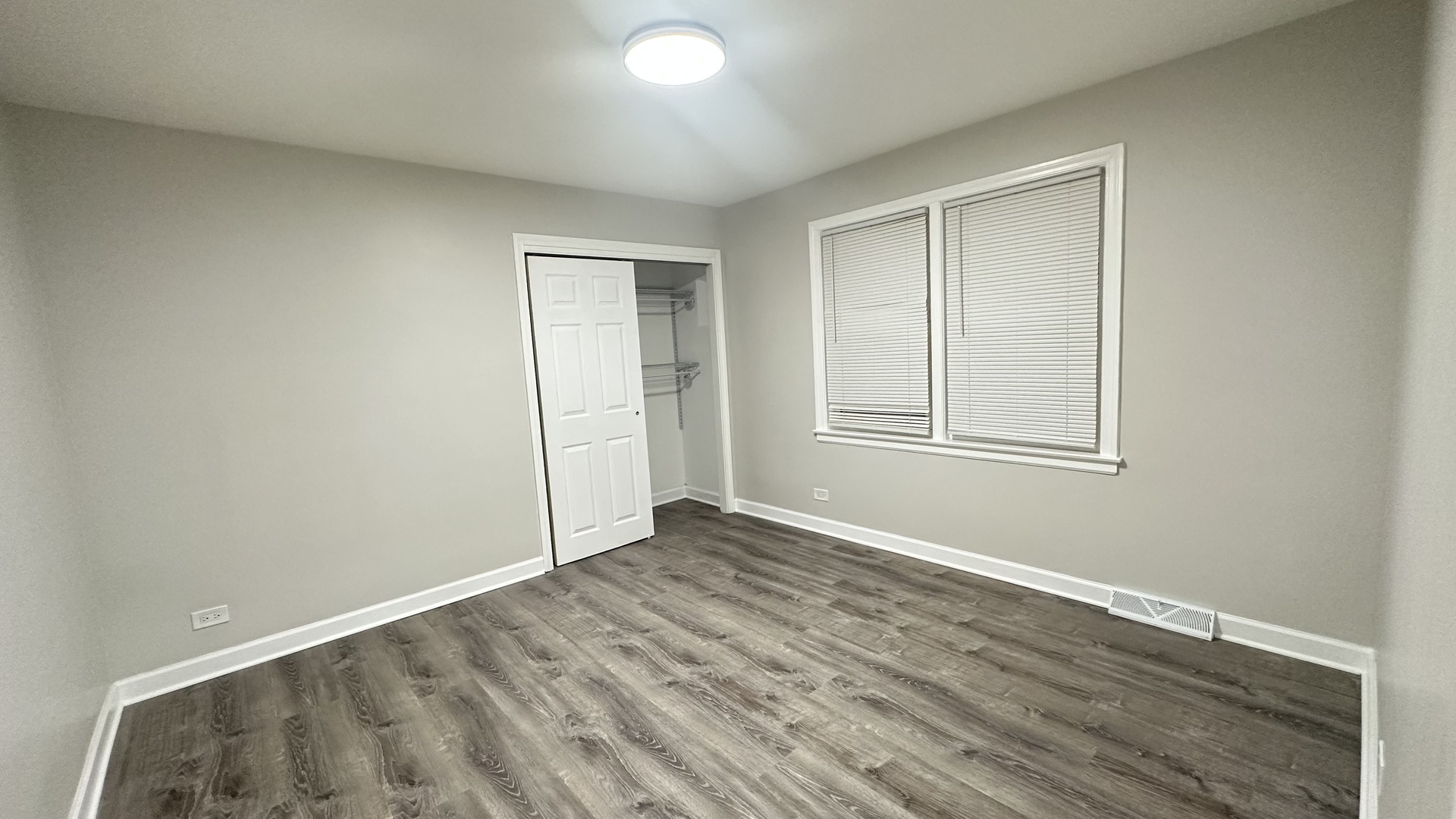 5715 North Spaulding Avenue, Unit 1 Chicago, IL 60659 - Photo 9 of 15 an empty room with wooden floor and closet