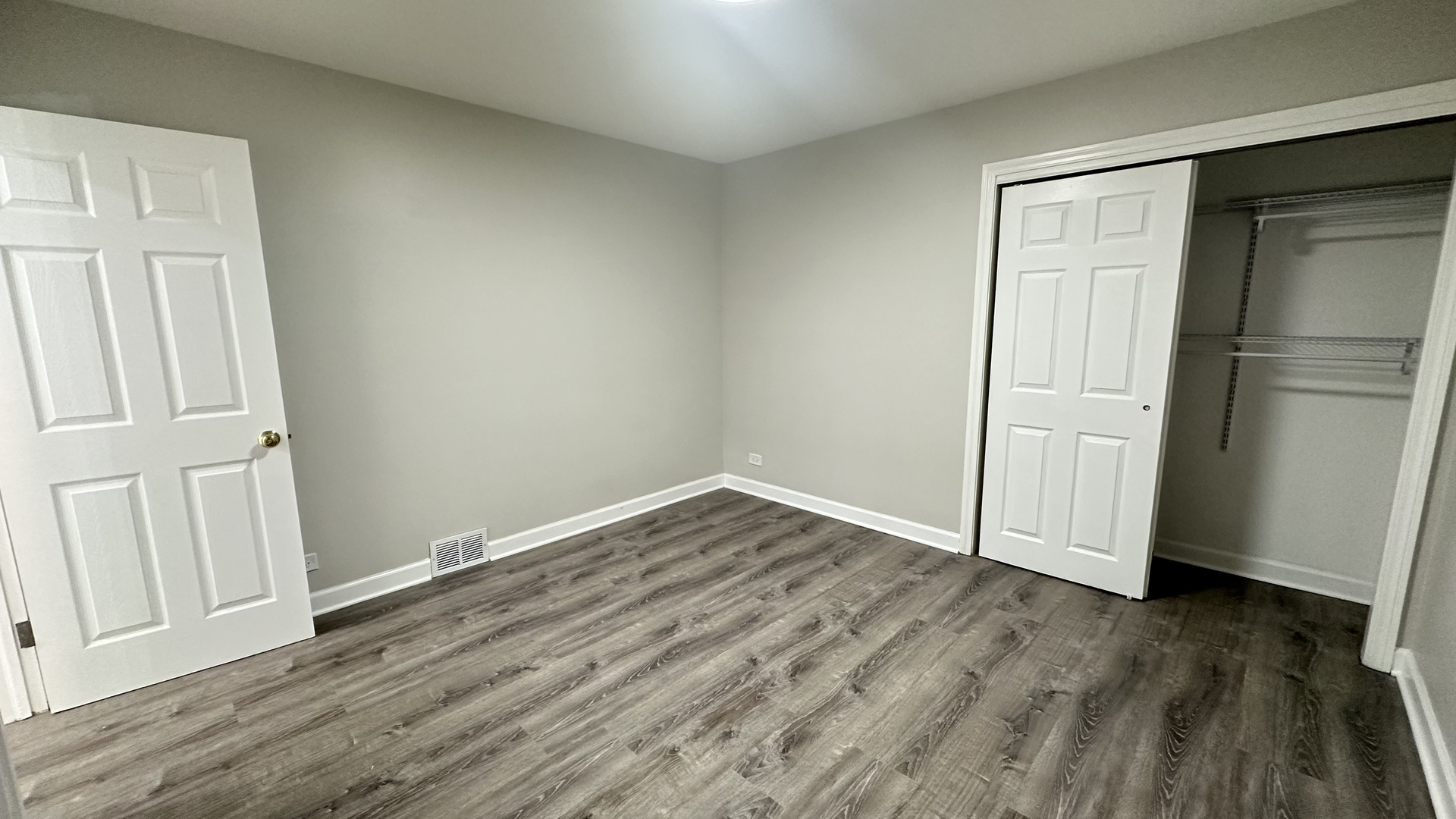 5715 North Spaulding Avenue, Unit 1 Chicago, IL 60659 - Photo 10 of 15 an empty room with wooden floor and closet