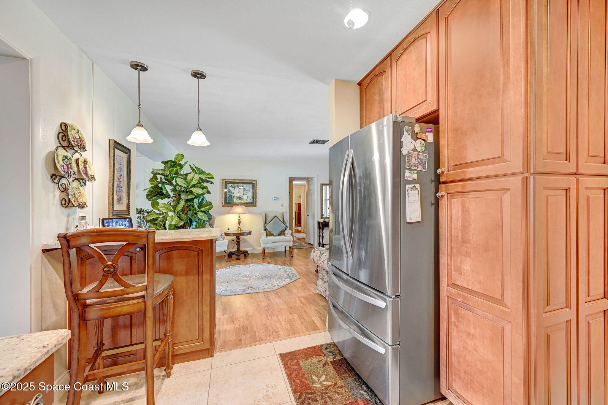 1208 Duke Way Cocoa, FL 32922 - Photo 11 of 34 a kitchen with stainless steel appliances granite countertop a refrigerator and a wooden cabinets