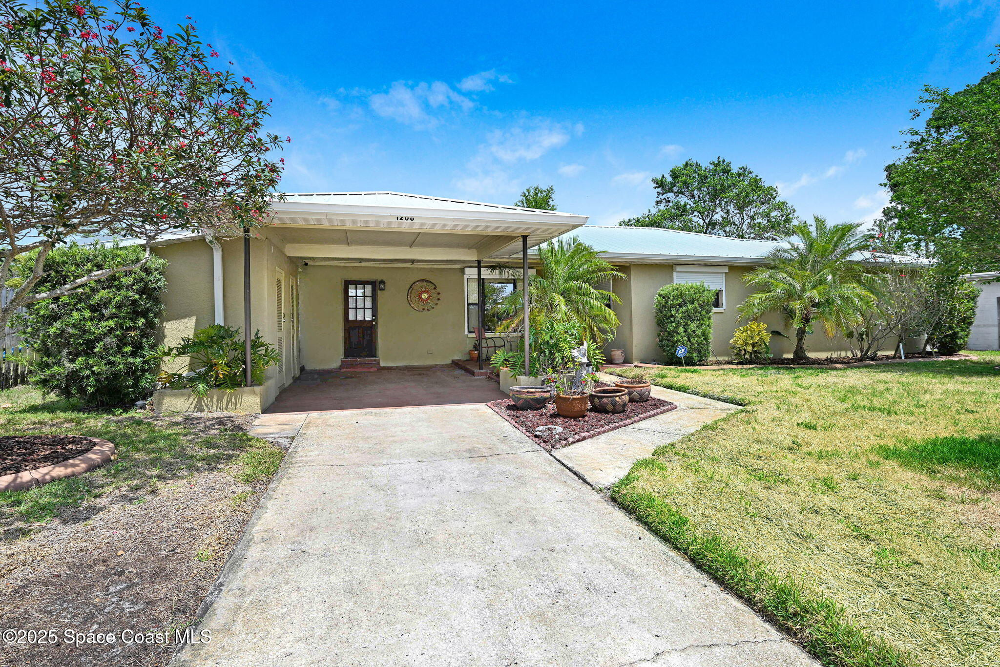1208 Duke Way Cocoa, FL 32922 - Photo 2 of 34 a view of a patio with table and chairs under an umbrella