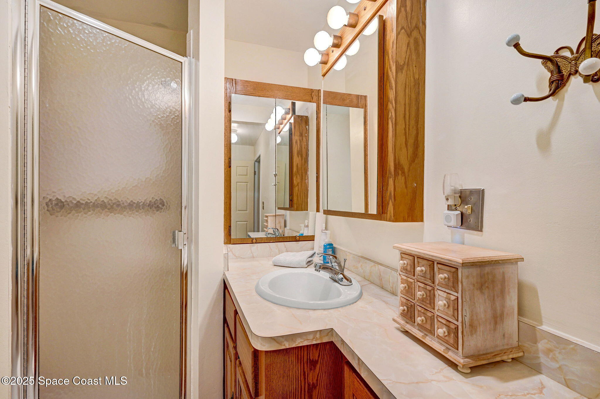 1208 Duke Way Cocoa, FL 32922 - Photo 25 of 34 a bathroom with a sink and a mirror