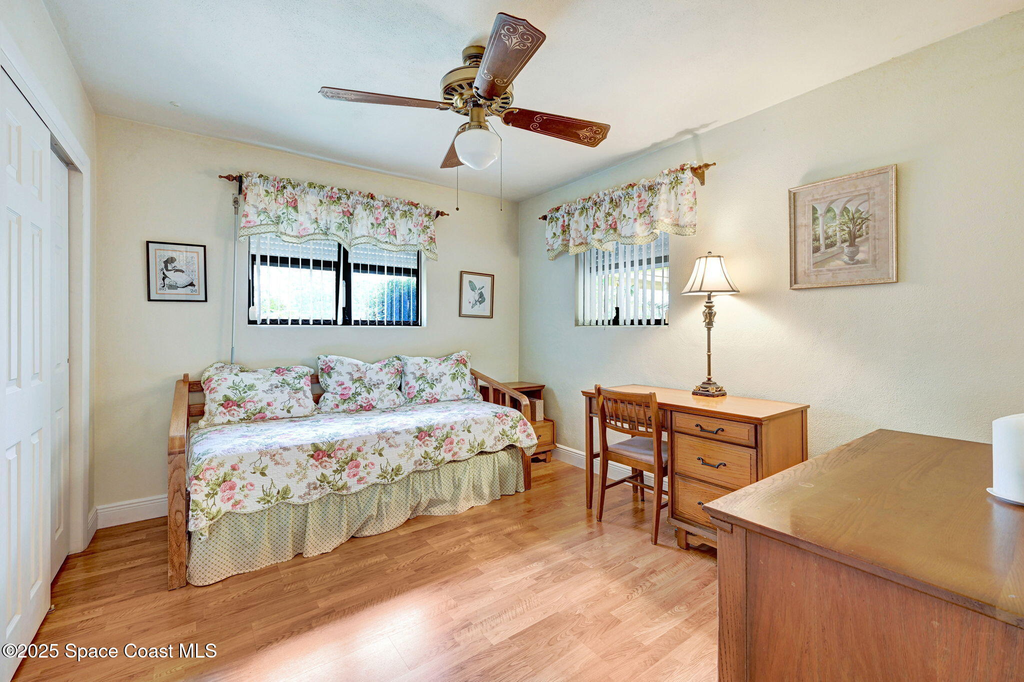 1208 Duke Way Cocoa, FL 32922 - Photo 27 of 34 a bedroom with a bed and a table in it