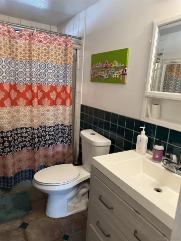 a bathroom with a toilet a sink and a shower