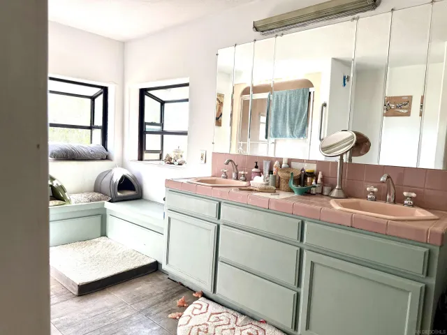 a spacious bathroom with sinks mirror and a bathtub