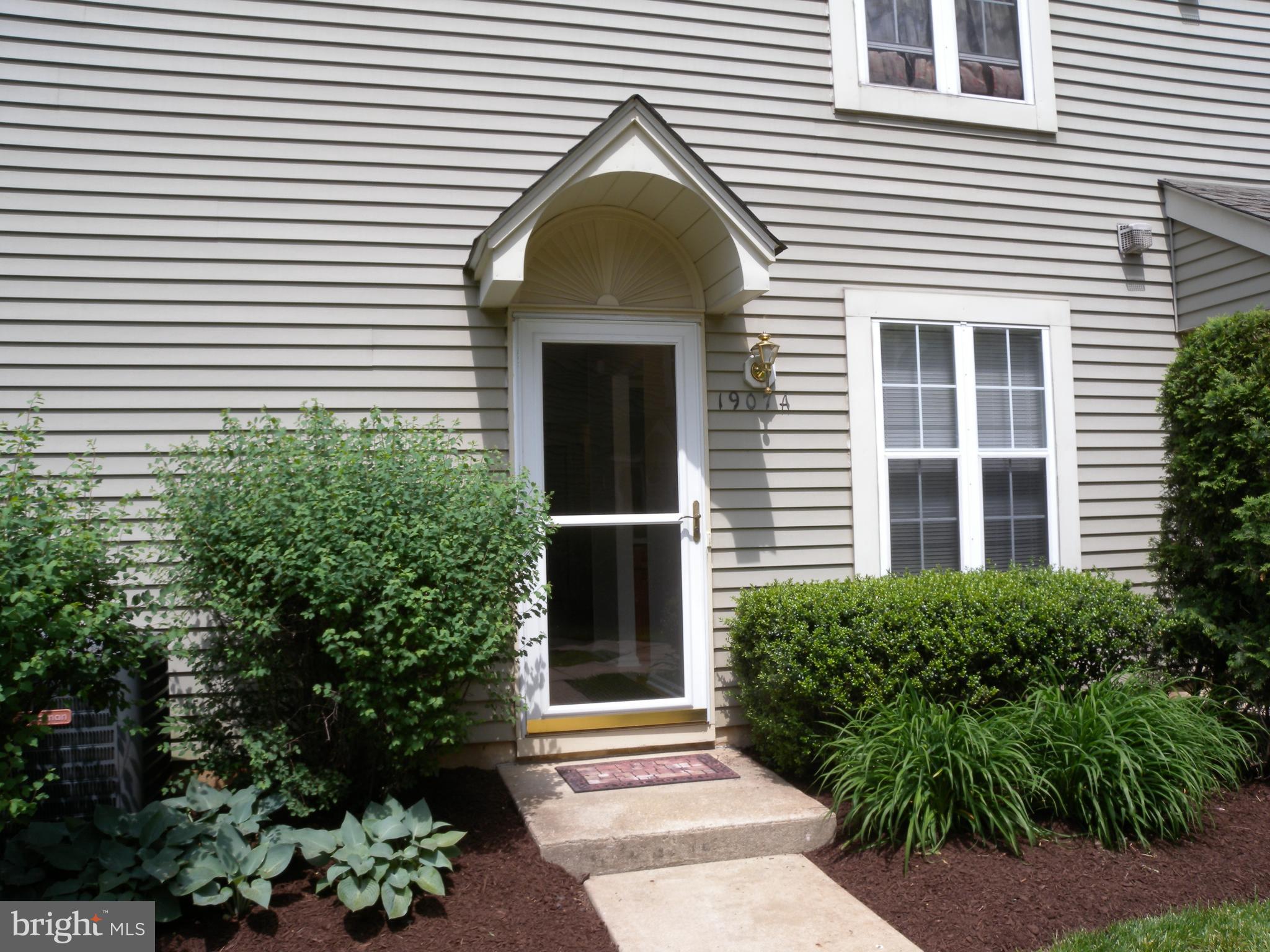 a view of a house with potted plants