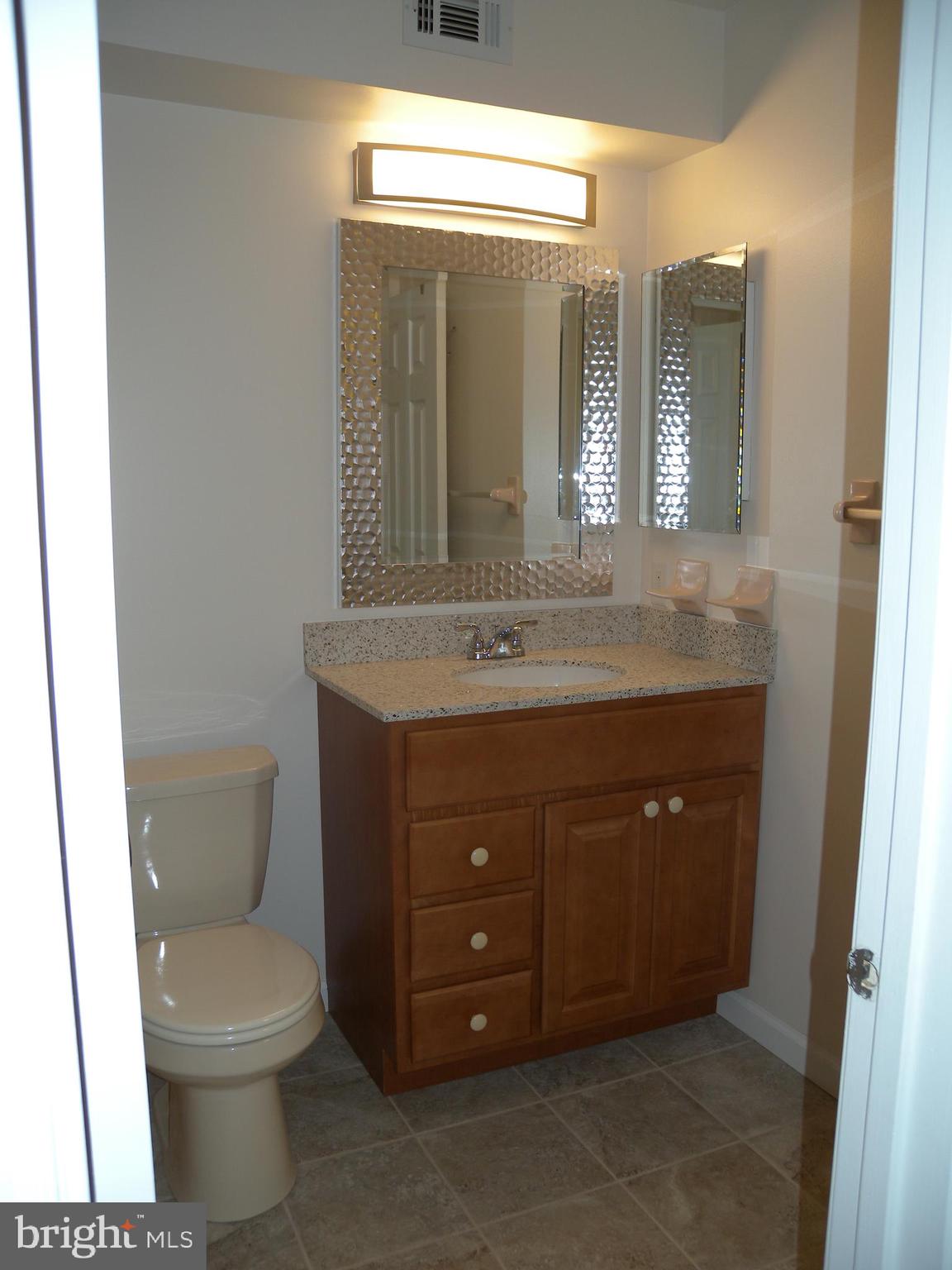 1907 A Sutton Place Mount Laurel, NJ 08054 - Photo 11 of 23 a bathroom with a toilet a sink and mirror