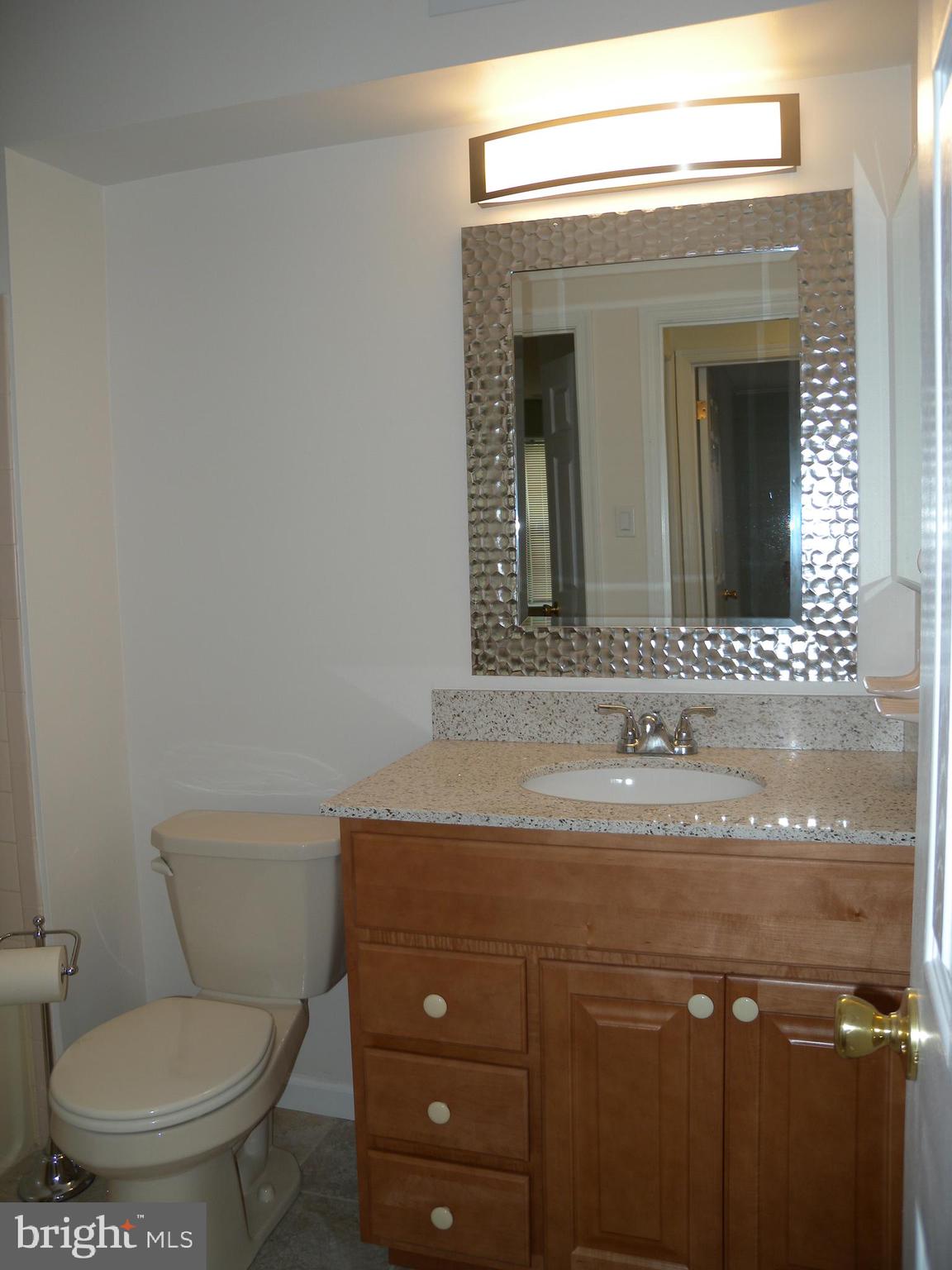 1907 A Sutton Place Mount Laurel, NJ 08054 - Photo 12 of 23 a bathroom with a toilet sink and mirror