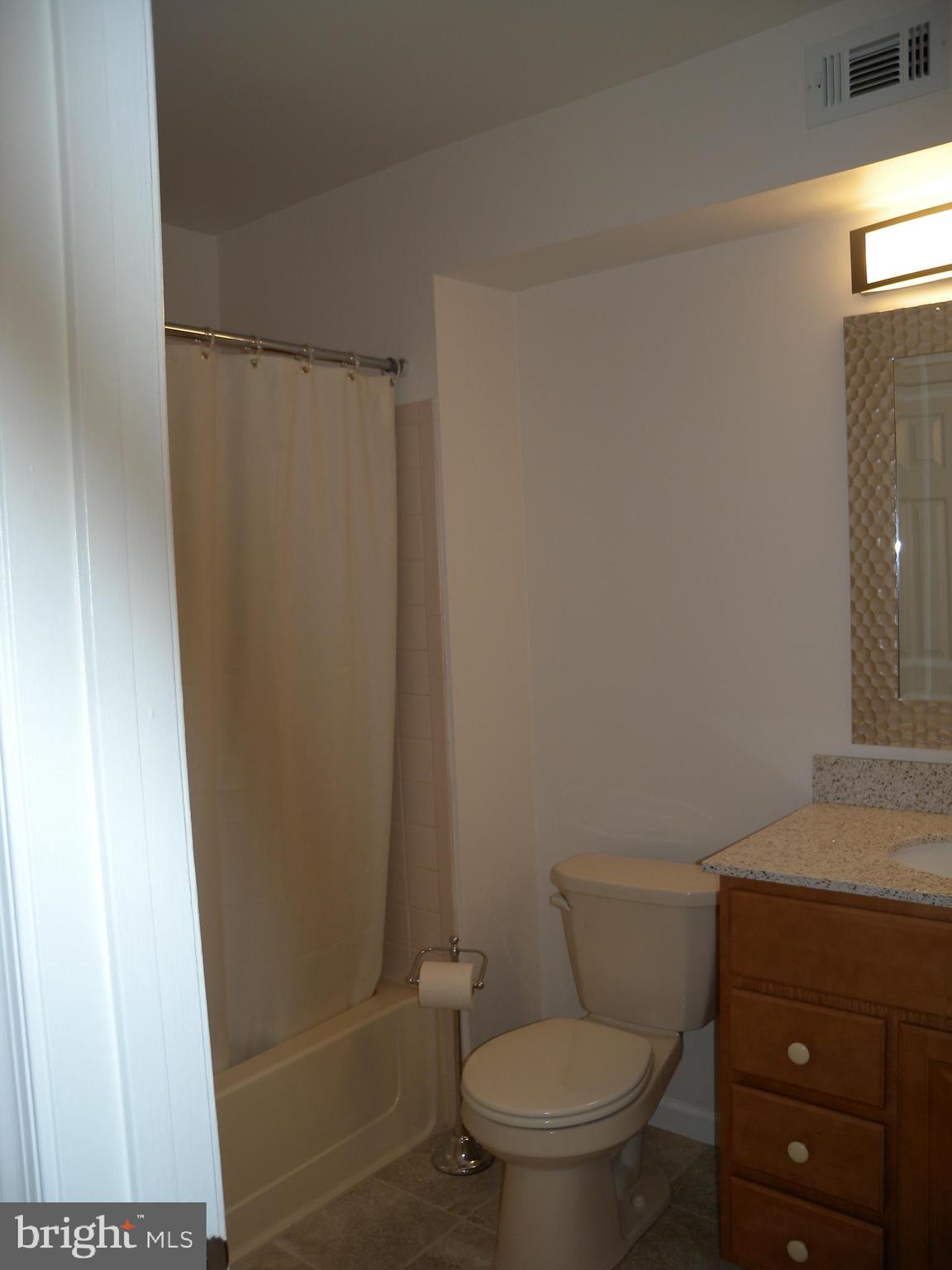 1907 A Sutton Place Mount Laurel, NJ 08054 - Photo 13 of 23 a white toilet sitting next to a shower curtain