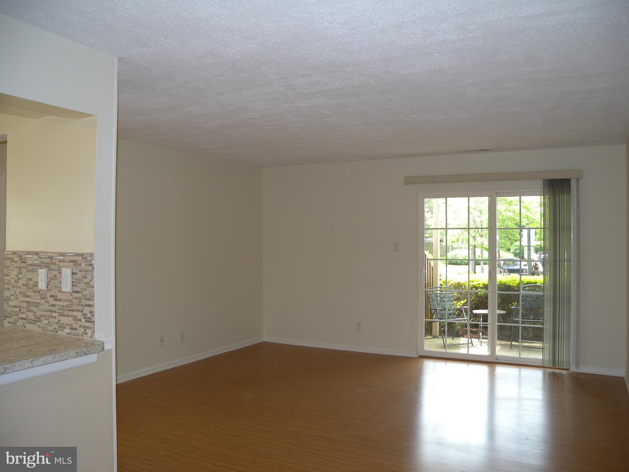 1907 A Sutton Place Mount Laurel, NJ 08054 - Photo 4 of 23 a view of an empty room and wooden floor
