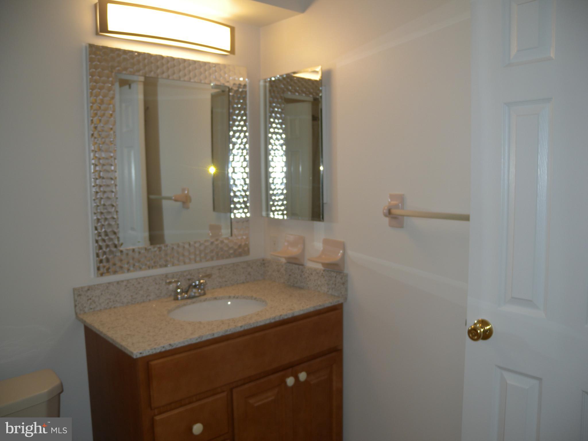 1907 A Sutton Place Mount Laurel, NJ 08054 - Photo 10 of 23 a bathroom with a sink and mirror