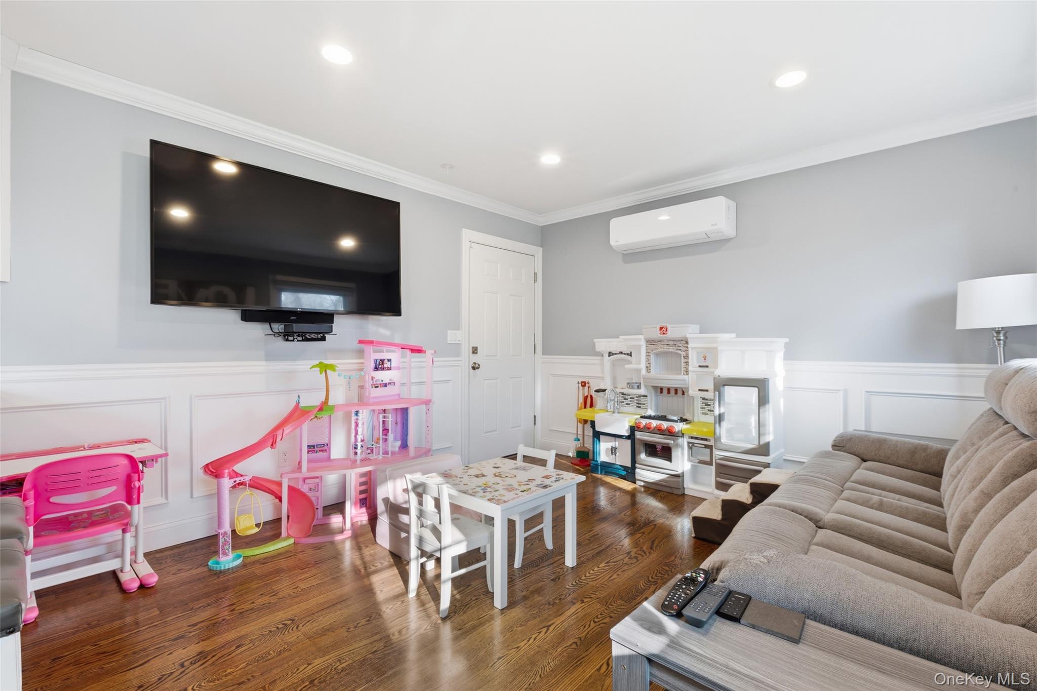 39 Benjamin Road Mahopac, NY 10541 - Photo 11 of 39 Living area featuring a decorative wall, wainscoting, ornamental molding, dark wood finished floors, and recessed lighting