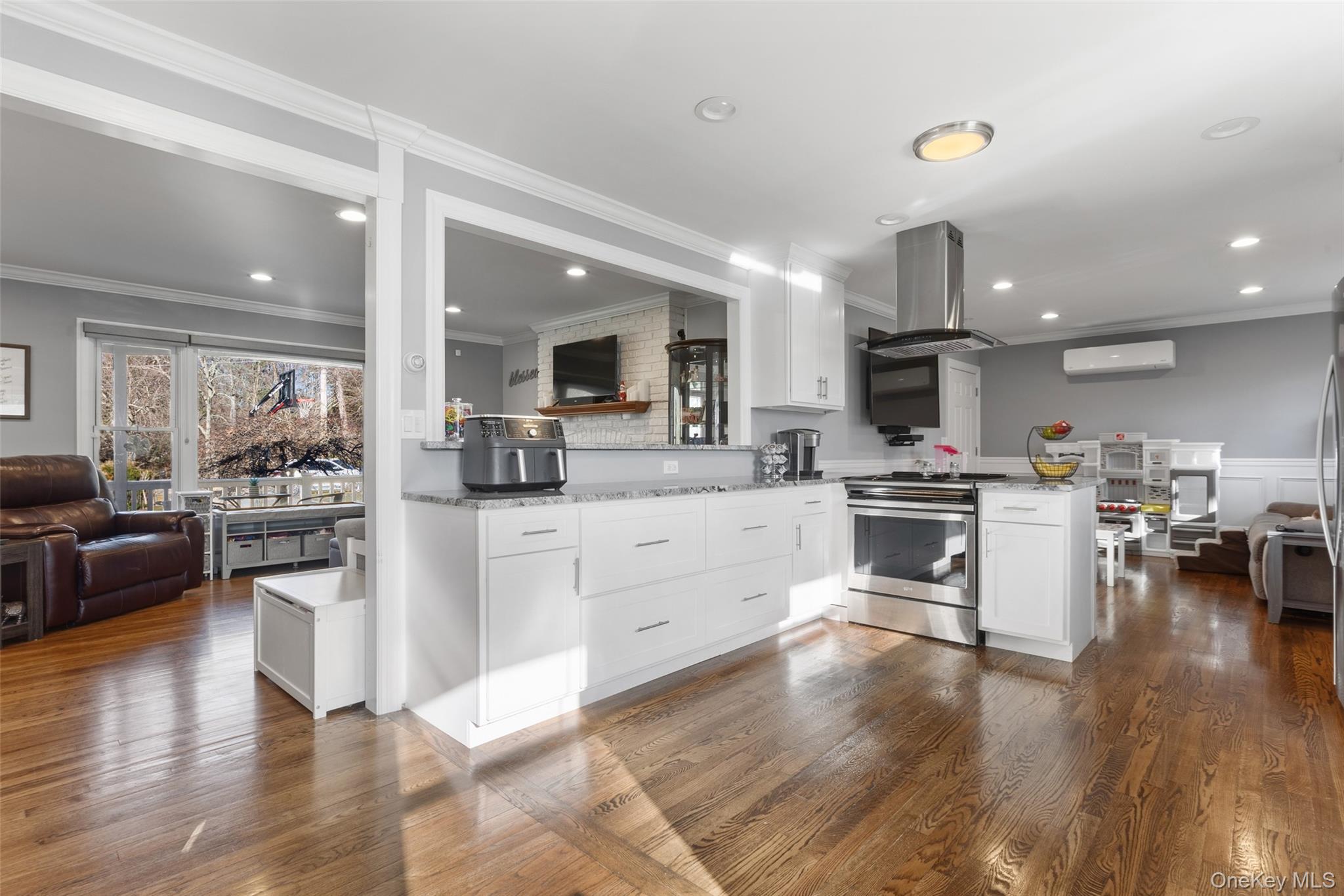 39 Benjamin Road Mahopac, NY 10541 - Photo 39 of 39 Featuring open floor plan, a peninsula, crown molding, dark wood finished floors, and stainless steel stove & elegant vent.