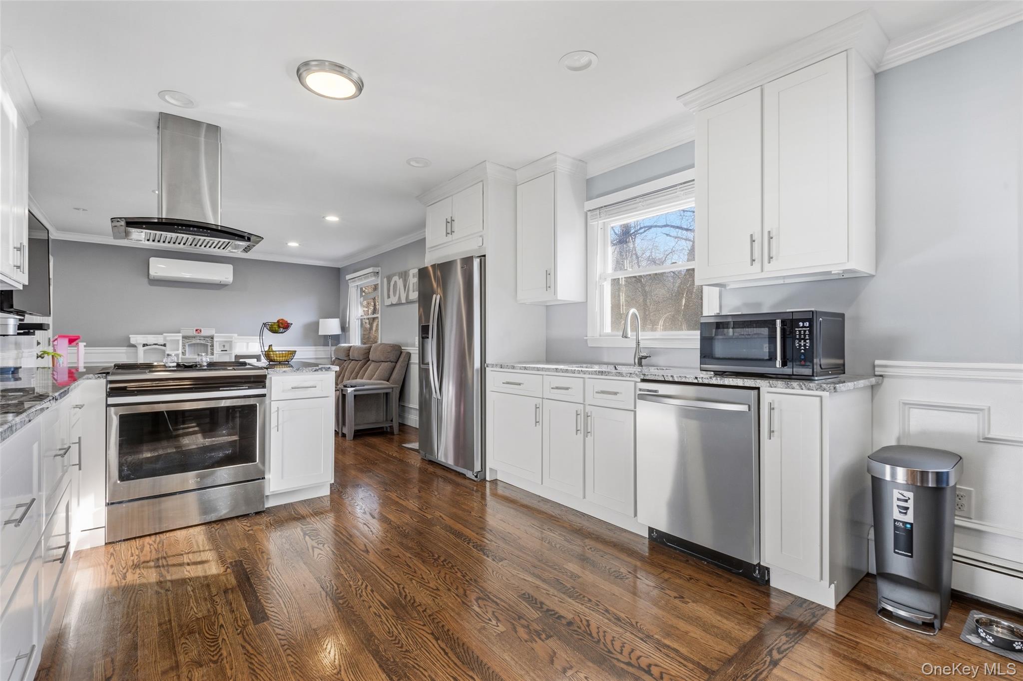 39 Benjamin Road Mahopac, NY 10541 - Photo 7 of 39 Kitchen featuring crown molding, light stone countertops, stainless steel appliances, white cabinets, island & range hood
