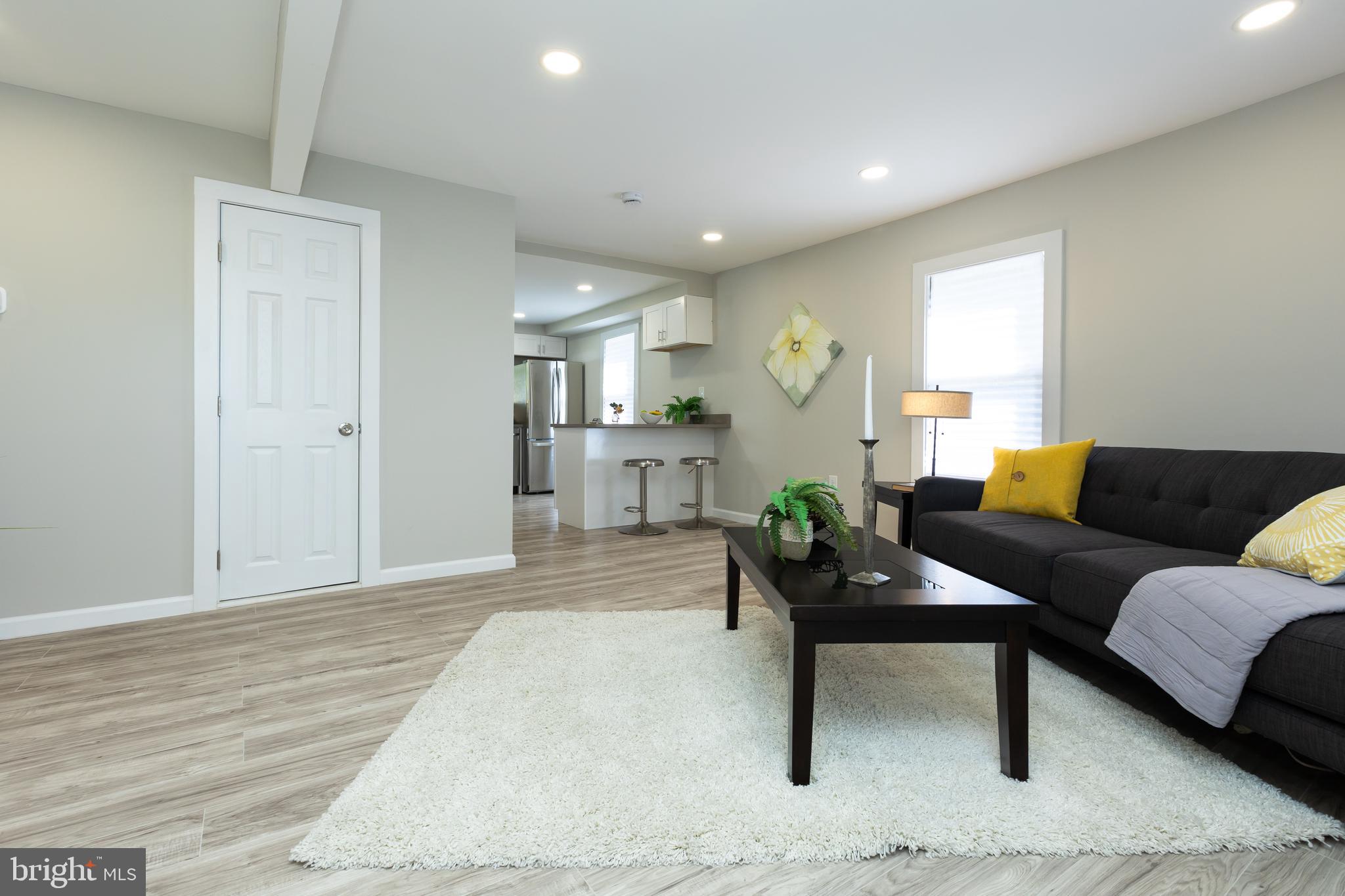 2407 Hammonds Ferry Road Halethorpe, MD 21227 - Photo 12 of 43 a living room with furniture and a wooden floor