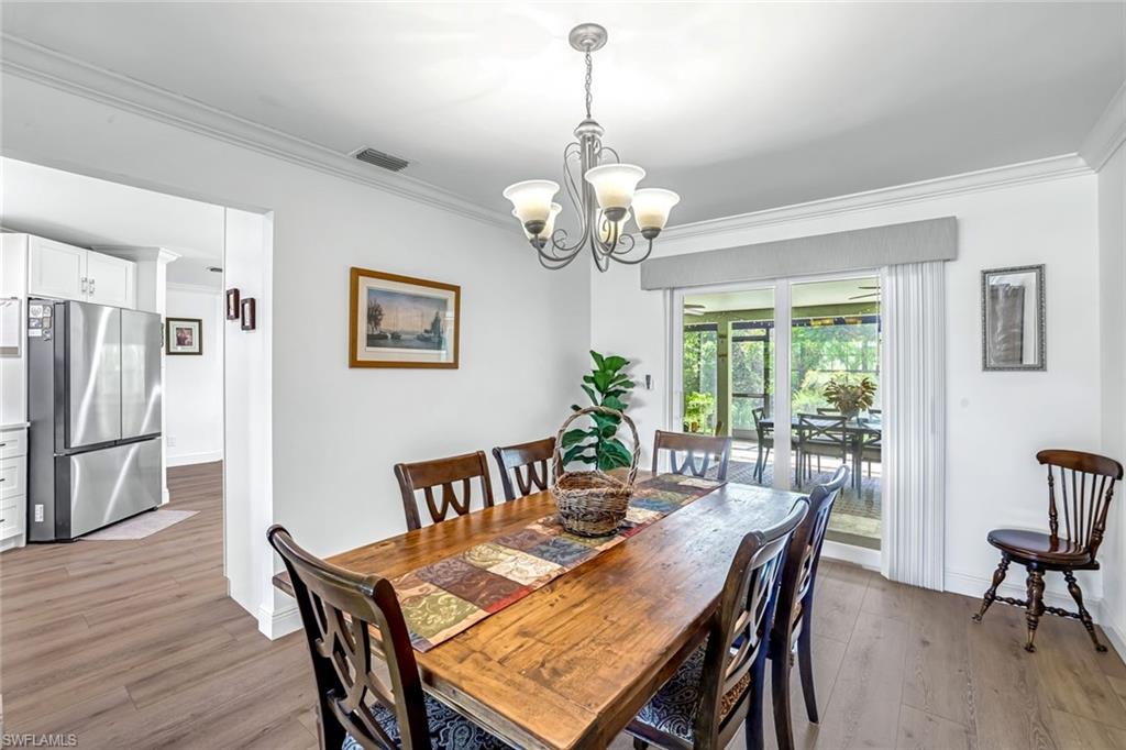 401 Panay Avenue Naples, FL 34113 - Photo 12 of 47 a view of a dining room with furniture window and wooden floor