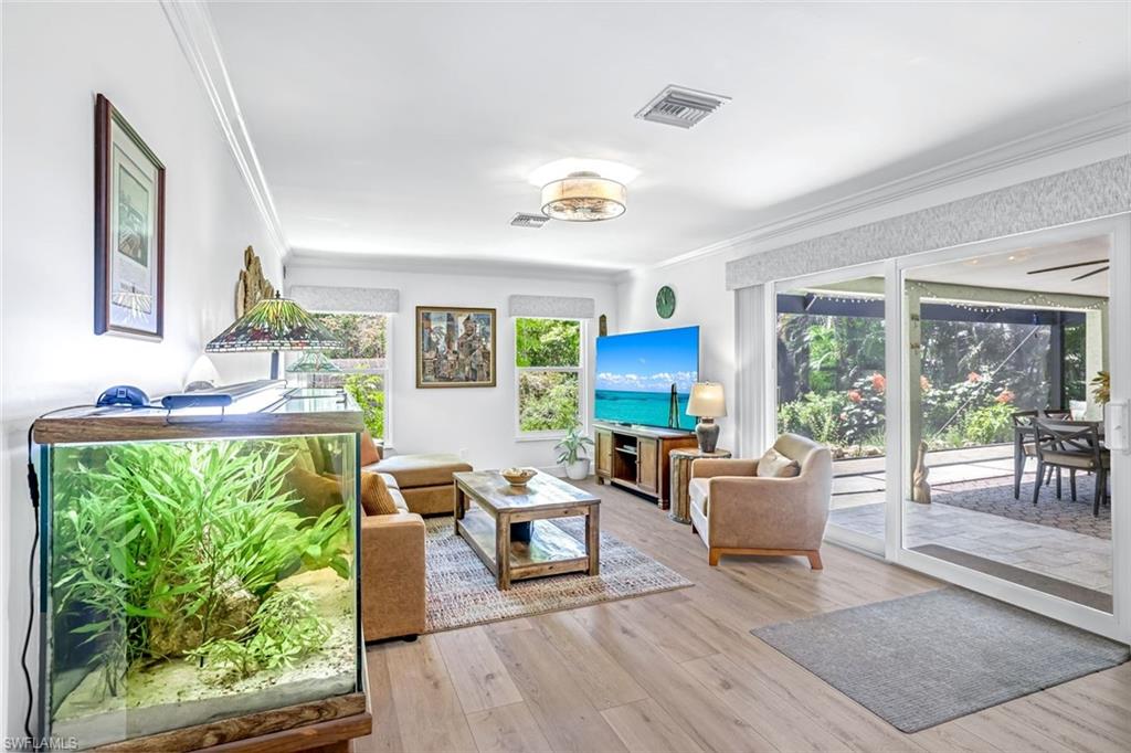 401 Panay Avenue Naples, FL 34113 - Photo 18 of 47 a living room with furniture and a large window