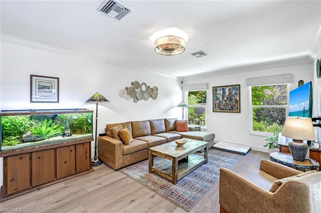 401 Panay Avenue Naples, FL 34113 - Photo 19 of 47 a living room with furniture and a large window