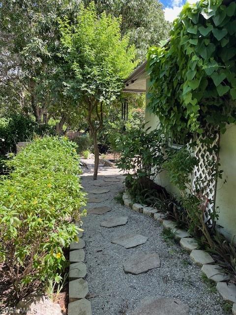 401 Panay Avenue Naples, FL 34113 - Photo 36 of 47 a view of a garden with large trees
