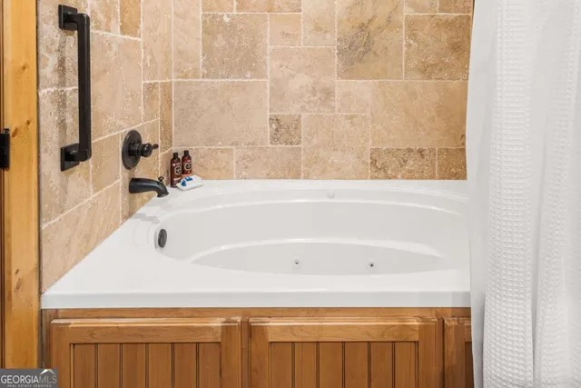 a view of a yard with chairs and a table