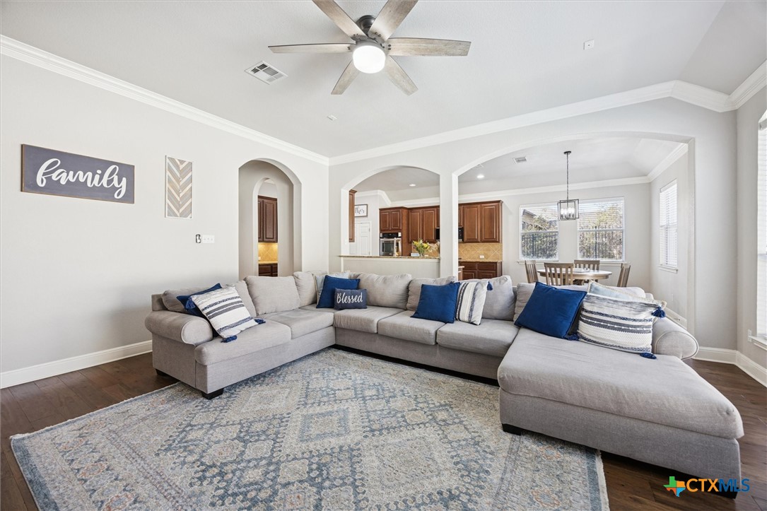 2309 First View Leander, TX 78641 - Photo 13 of 31 A spacious family room features tall ceilings and a wall of windows that brighten the space while overlooking the backyard.