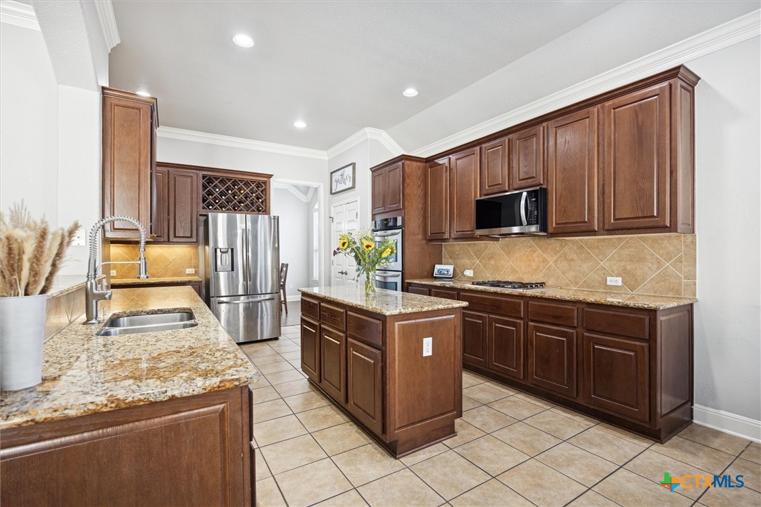 2309 First View Leander, TX 78641 - Photo 15 of 31 The kitchen offers abundant cabinetry, expansive countertops, and a large center island designed for both meal prep and gathering.