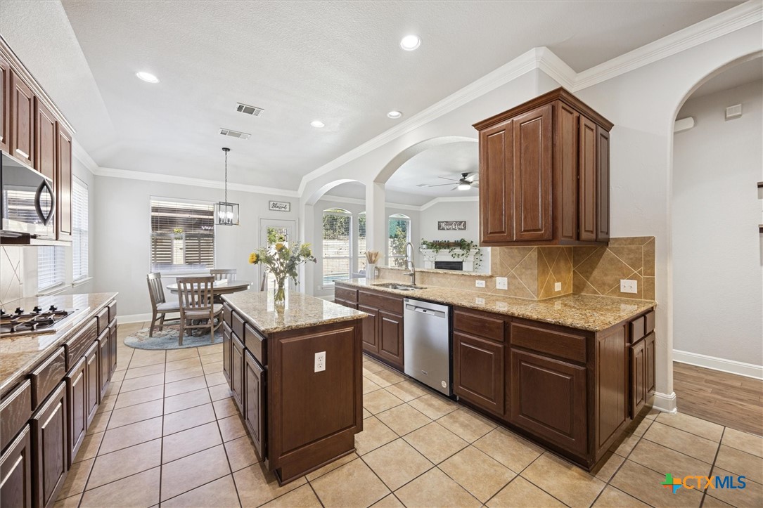 2309 First View Leander, TX 78641 - Photo 16 of 31 An open layout allows the kitchen to overlook multiple room through elegant arches, creating a welcoming central hub of the home.